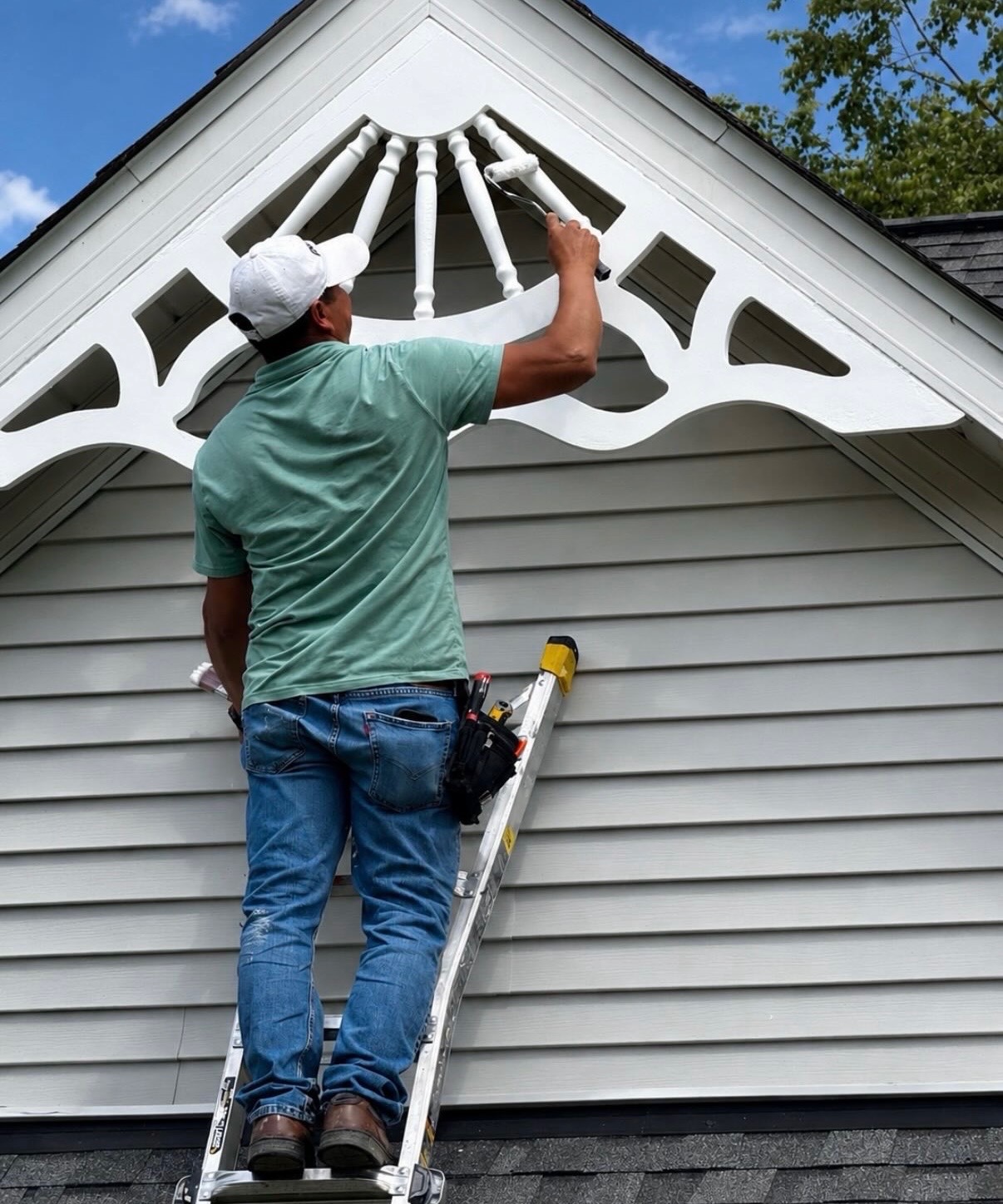 Leo's Coat painter carefully coating decorative exterior trim
